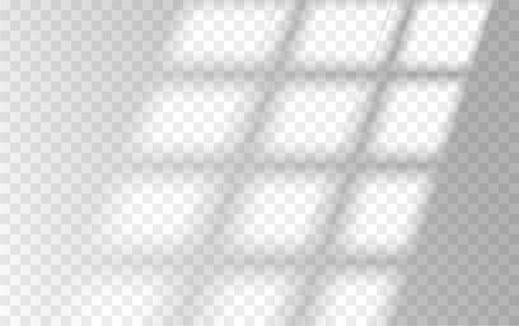 Sunlight streaming through window casting grid-like shadows on transparent surface