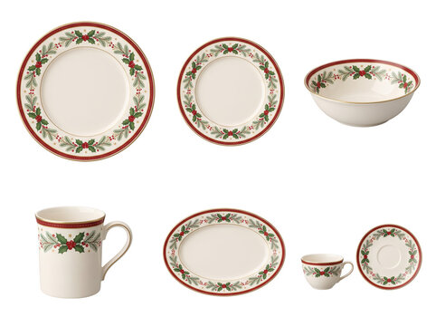 Set of cream ceramic dinnerware decorated with festive holly leaves and red berries patterns for holiday dining isolated on a transparent background