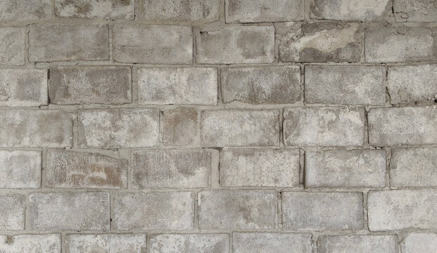 Rough cinder block wall texture background, horizontal view of grey concrete blocks masonry