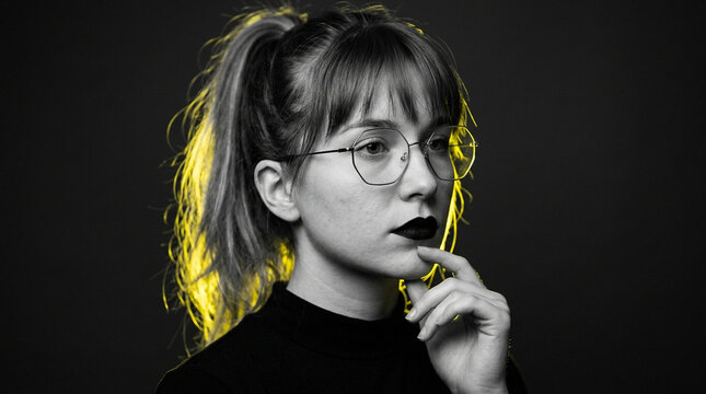 Young woman with yellow hair accents in black and white portrait