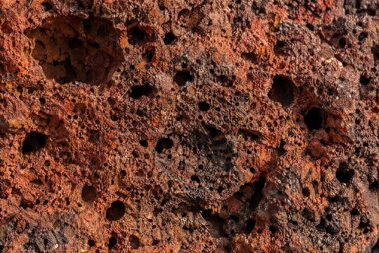 Rusty red volcanic scoria with gas bubble holes