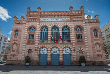 Front facade of the Gran Teatro Falla, a historic neo-Mudéjar theater in Cadiz, Spain, with symmetrical architecture and decorative brickwork © ihervas
