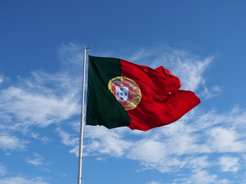 Portugal flag rippling high in the clear sky