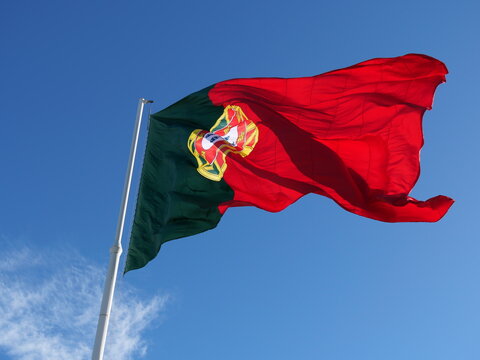 Portugal flag rippling high in the clear sky