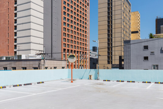 Rooftop Parking Lot with Traffic Mirror and Patterned Building