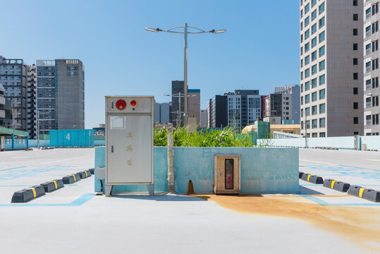 Rooftop Parking Lot with Hydrant Box and Modern Buildings