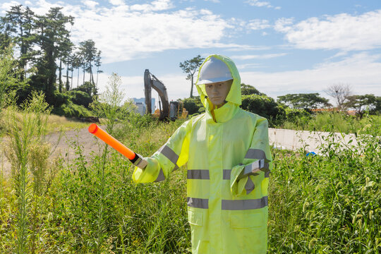 Construction Mannequin in Neon Suit Pointing with Safety Wand.