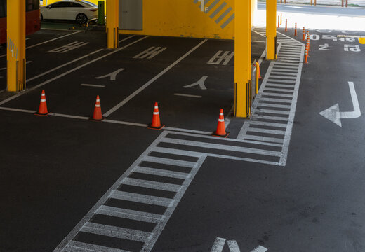 Indoor Parking Lot with Yellow Pillars, Cones, and Road Markings