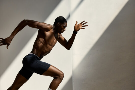 Runner trains indoors in bright light during the afternoon