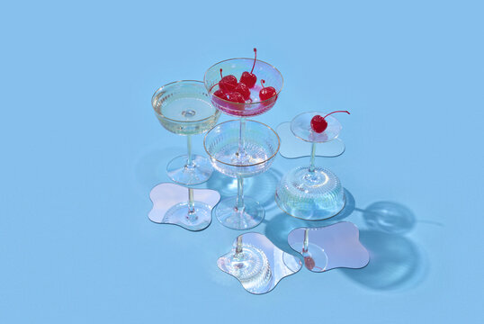 Coupe glasses with cherries and mirror shapes