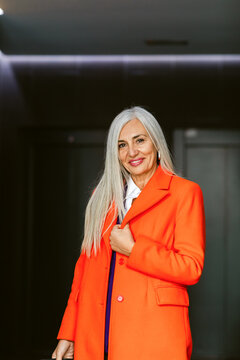 Woman Smiling Orange Coat Indoors