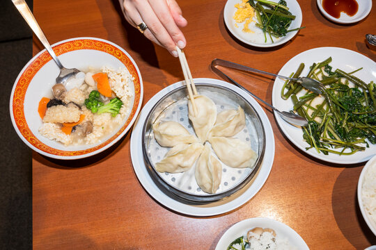 Diner Picking Up Steamed Dumpling With Chopsticks