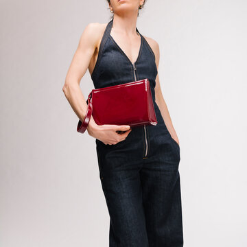 Stylish Denim Jumpsuit With Red Clutch Bag