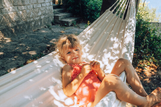 Girl Resting In Shaded Hammock