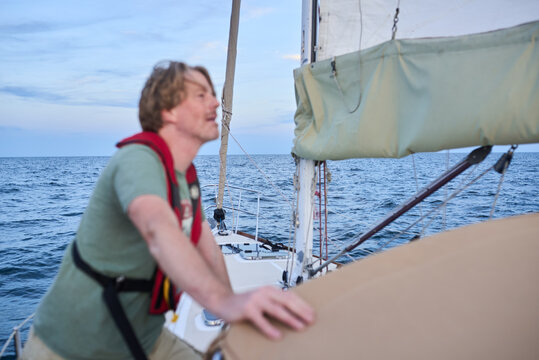 Man checking main sail