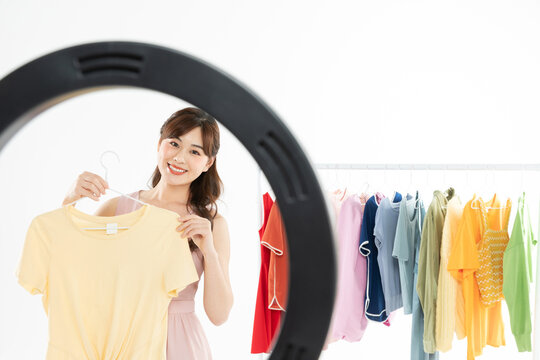 Smiling Woman Selling Clothes Online Using Ring Light