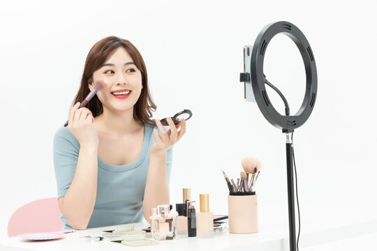 Young Asian Woman Livestreaming Makeup Tutorial with Ring Light