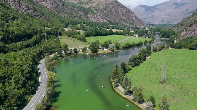 Aerial view of Lake Torrassa bright green algal bloom caused by extreme heatwave, Pyrenees, Spain"