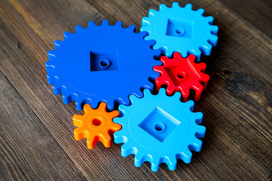 bright gears for great technology of team work and correct mechanism on wooden background
