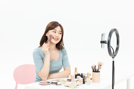Young Asian Woman Recording Beauty Tutorial With Smartphone and Ring Light