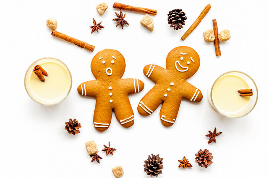 Eggnog for christmas evening. Two glasses near gignerbread cookie on white background top view