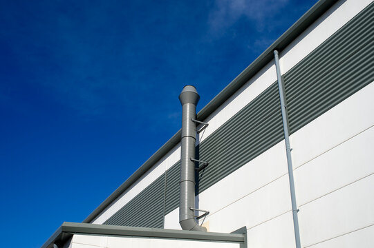 Industrial Ventilation Pipe Against a Deep Blue Sky