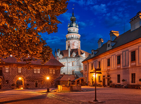 Czech Krumlov, Republic. Old Cesky Krumlov Castle. Medieval Antique Street with Houses and tower. Majestic blue hour after sunset night view from the court.
