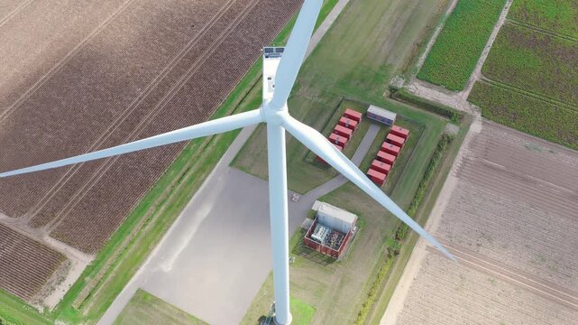 Aerial drone view of a battery energy storage system facility. Containers BESS units with transformers in a modern power grid station.