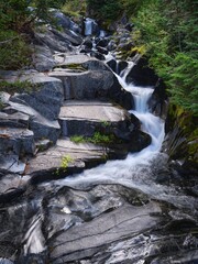 Waterfall cascades down boulders. © Gregory Johnston