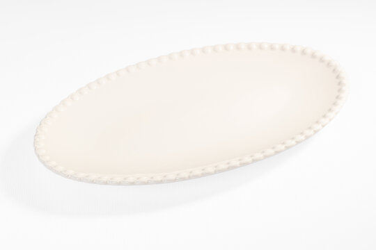 Oval ceramic serving platter with beaded rim detail, white glossy finish, empty surface for food presentation or table styling