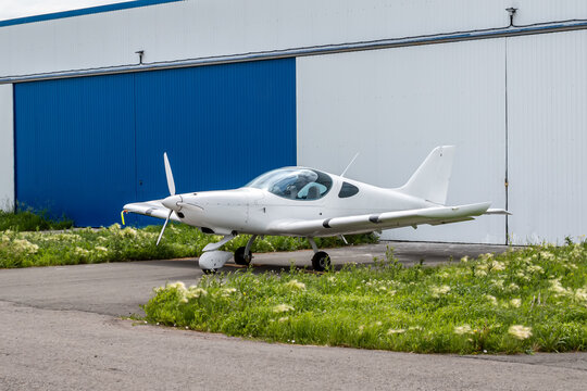 White small sports aircraft at the aviation hangar