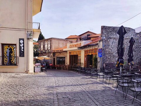 Photo of traditional cafes and taverns lining the historic cobblestone (kalderimi) Orfeos Street in the Old Town of Xanthi, Thrace, Northern Greece.