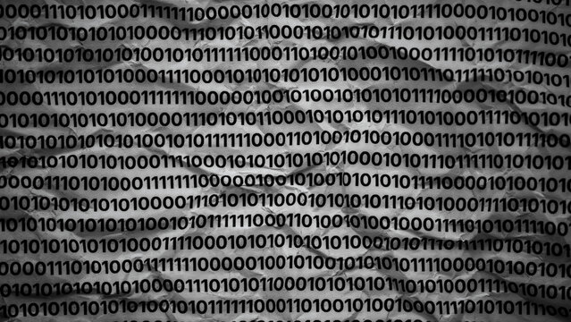 A textured background of crumpled paper covered with rows of repeating binary code. Black and white. Close up.