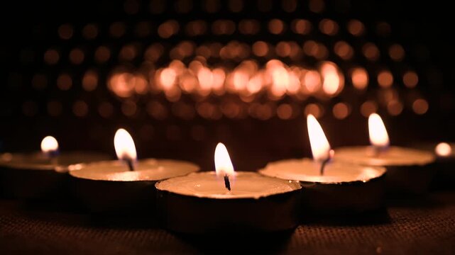 All Hallows' Day. Solemnity of All Saints. Burning Candles in Warm Bokeh Light for All Saints Day Remembrance, bokeh effect. 