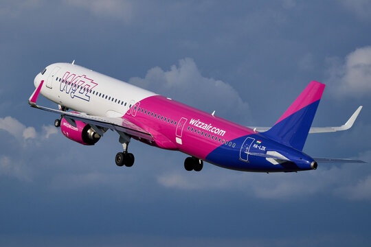 Wizz Air Airbus A321 HA-LZK passenger airliner climbing into cloudy sky after takeoff, Gdansk, Poland, September 2026