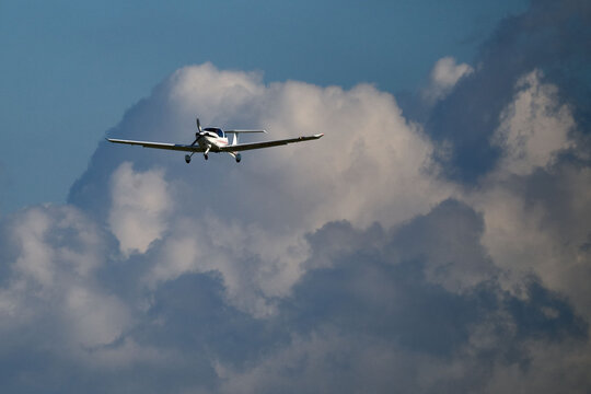 Small single-engine propeller airplane on approach against a dramatic cloudy sky near Gdansk, Poland, September 2026