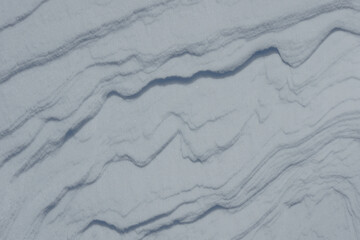 Sastrugi snow texture formed by strong winter wind © Gherzak