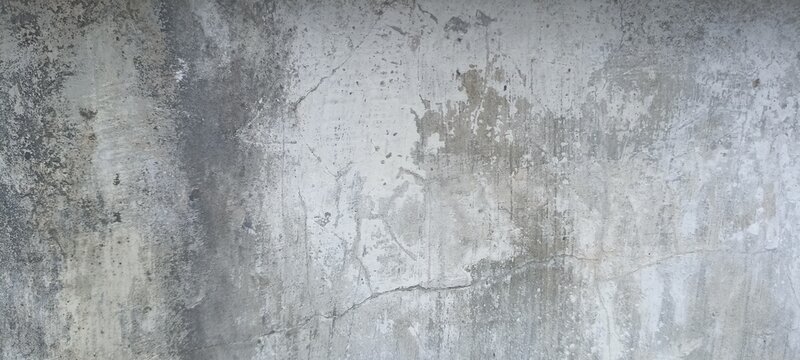Weathered concrete wall texture background with fine cracks, water stains, and raw grey plaster finish for industrial backdrops, minimal grunge design, and urban architecture