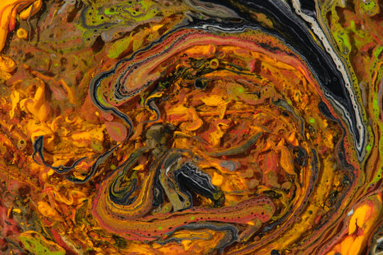 Complex abstract fluid art with vibrant orange, yellow and dark swirling paint vortex patterns.