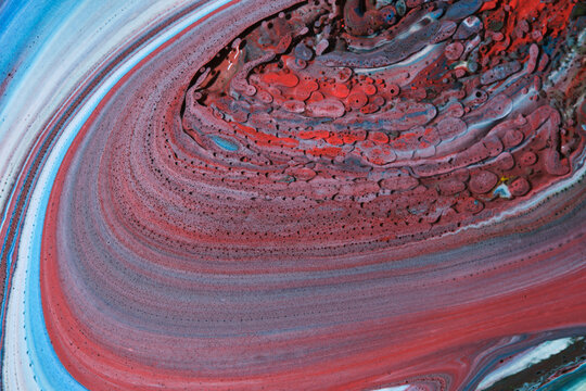 Dynamic abstract fluid art with blue, white and striking red textured cell patterns.