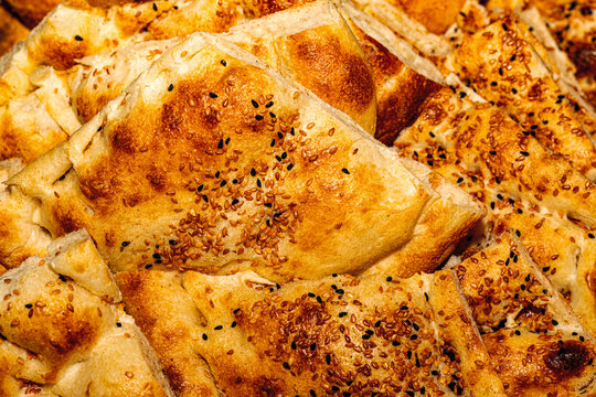 Traditional Turkish tirnak pidesi, dimpled flatbread freshly baked with sesame seeds.