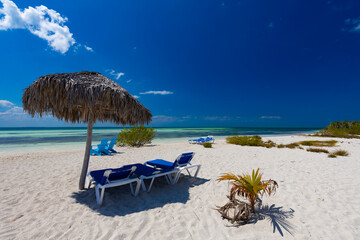 Tropical sandy beach and an exotic view of the Atlantic Ocean against a blue sky with clouds in Cuba, Caribbean – background for projects, wallpaper © anettastar
