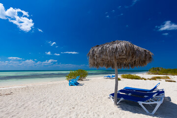 Tropical sandy beach and an exotic view of the Atlantic Ocean against a blue sky with clouds in Cuba, Caribbean – background for projects, wallpaper © anettastar