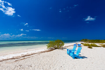 Tropical sandy beach and an exotic view of the Atlantic Ocean against a blue sky with clouds in Cuba, Caribbean – background for projects, wallpaper © anettastar