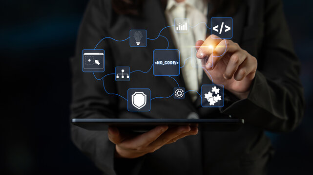 Business Professional Using Tablet to Access Digital Interface with Icons Representing Technology, Data, and Development Innovations Quark.