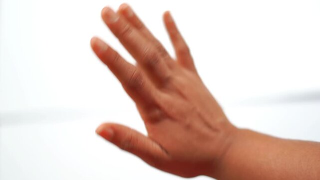 One Hand Waving Goodbye in Farewell Gesture on White Background. Closeup