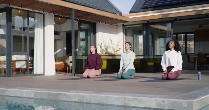 Three African American women following cue kneeling on yoga mats poolside breathing for relaxation