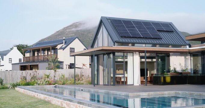 Gentle camera push is moving right and forward, showcasing modern house, pool and solar panels