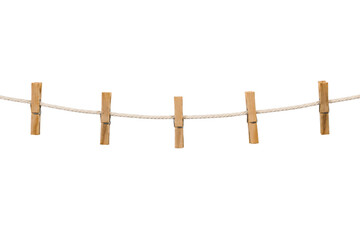 Five wooden clothespins securely hold a white rope clothesline, creating a simple and clean composition on a white background © no one