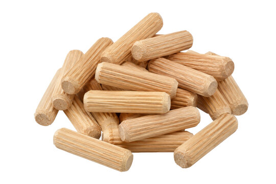 Pile of light brown wooden dowel pins for furniture assembly, isolated on a clean white background